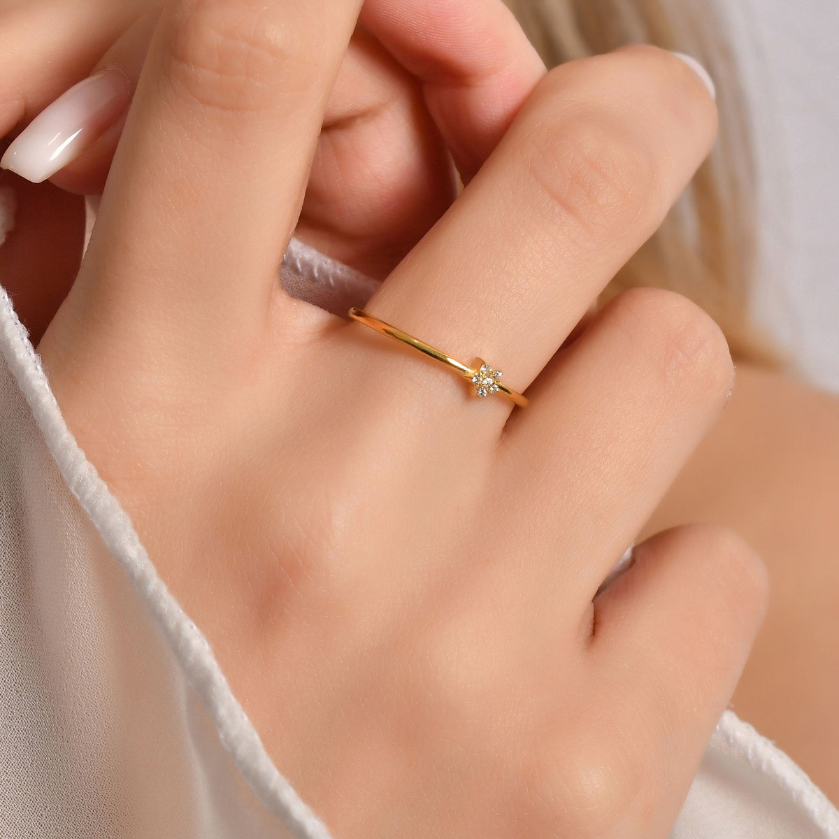 10K gold mini star cubic zirconia ring worn on hand, side view
