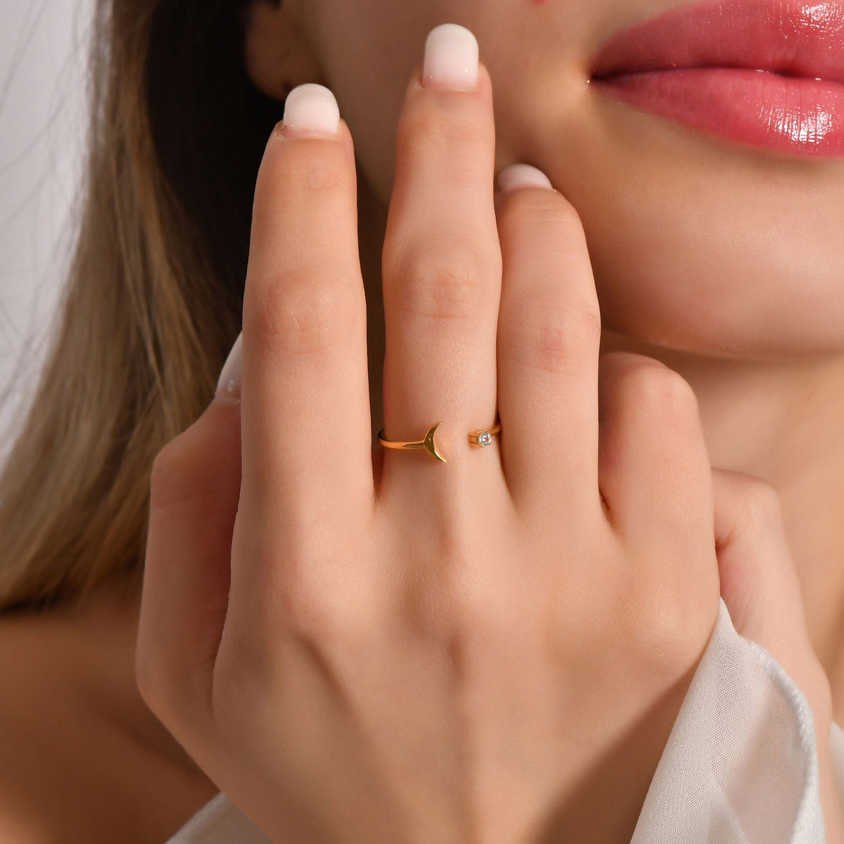 14K gold open crescent moon diamond ring on finger, close-up