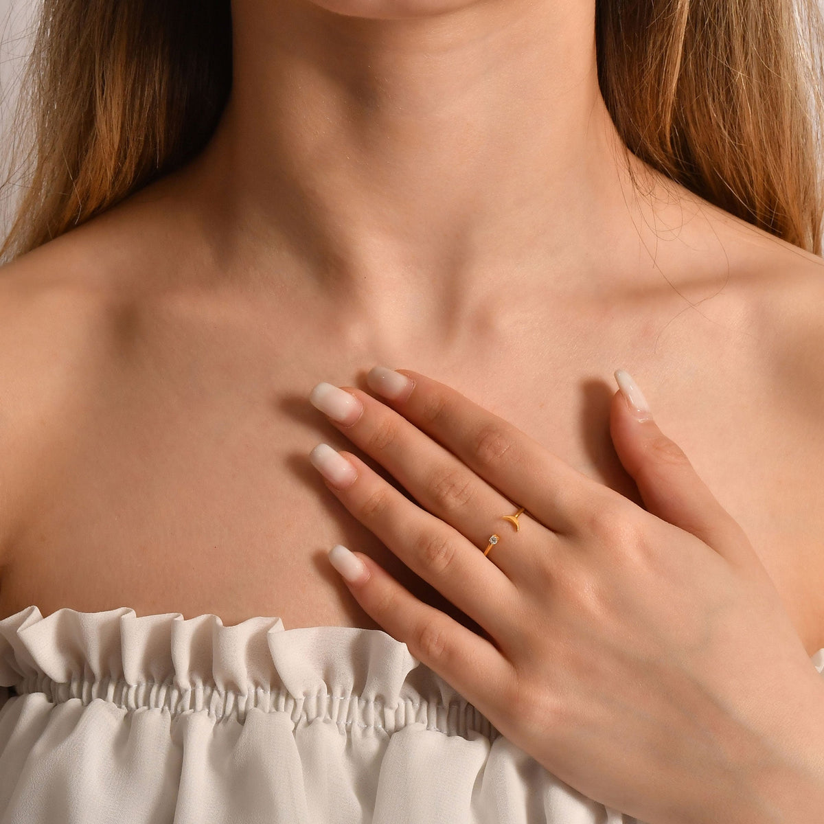 14K gold open crescent moon diamond ring on raised hand