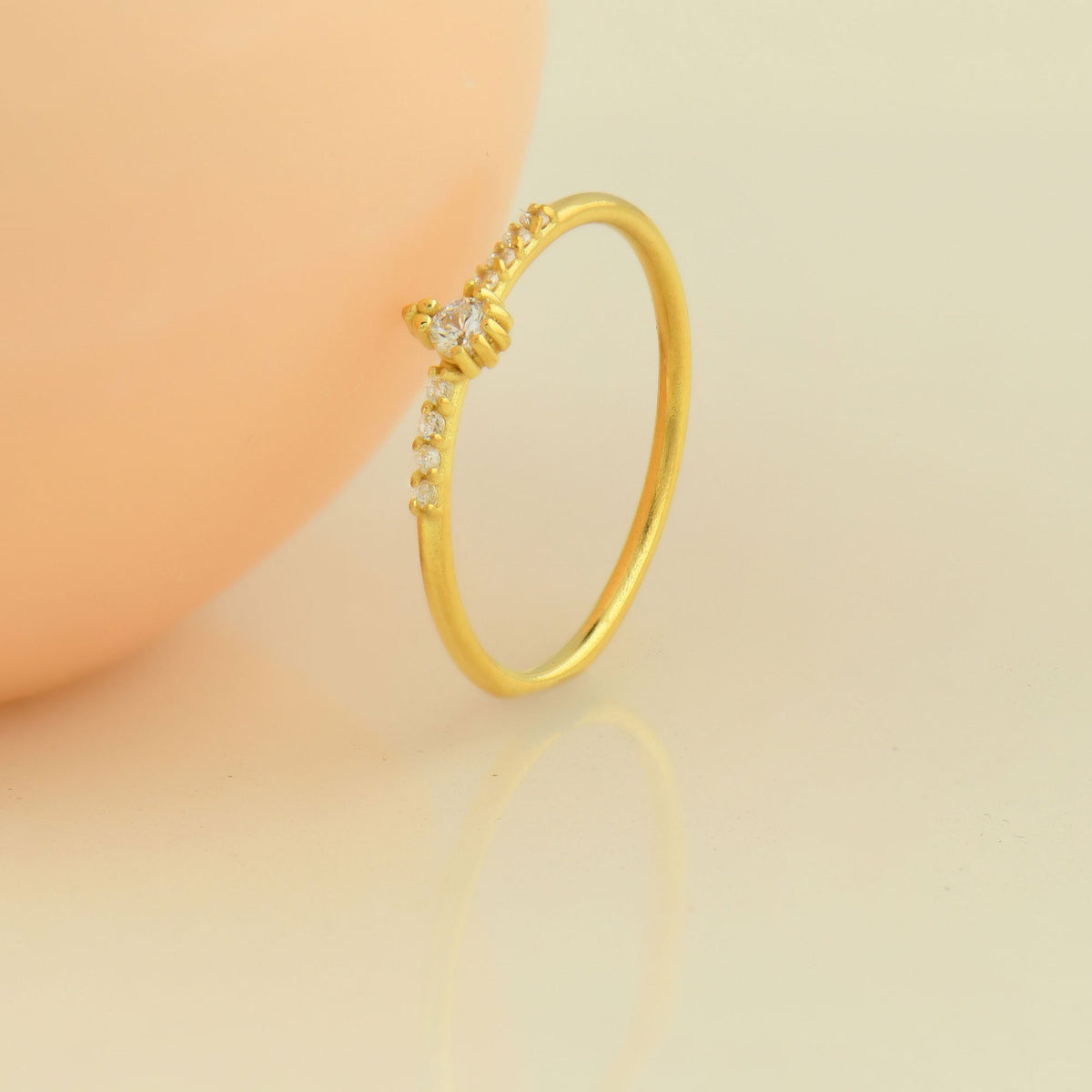 18K gold solitaire accent cubic zirconia ring on display