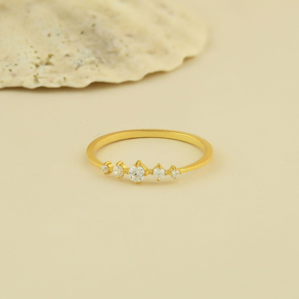 14K gold graduated five stone diamond ring on display