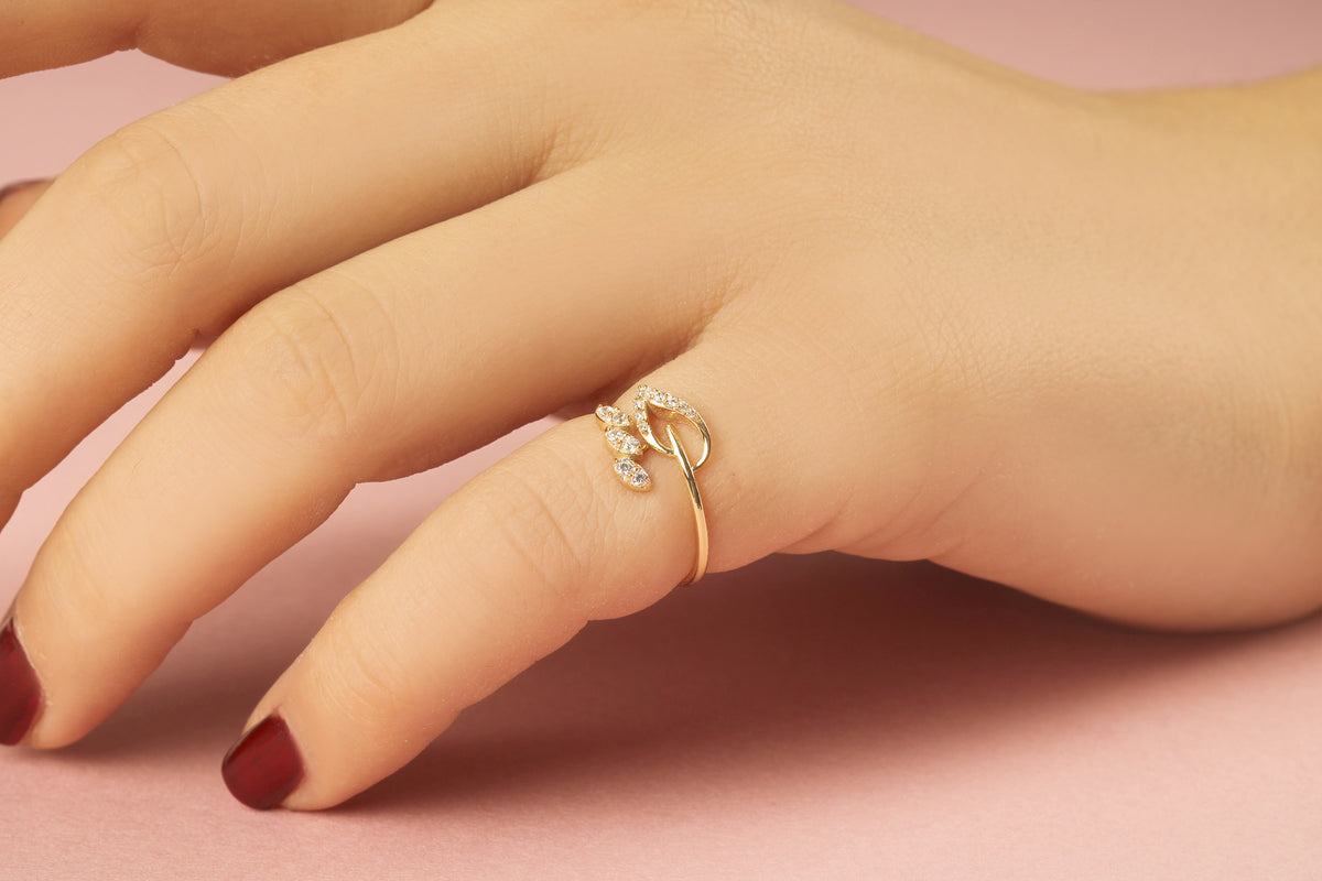 14K gold leaf ivy cubic zirconia ring worn on hand, close-up