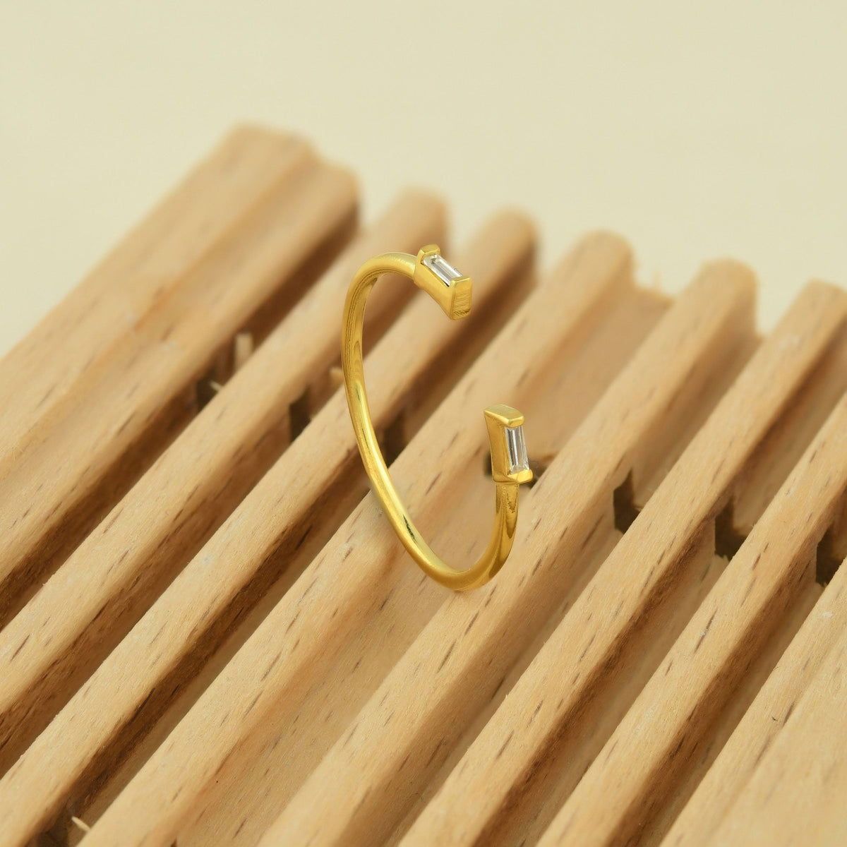 18K gold open baguette diamond ring on display