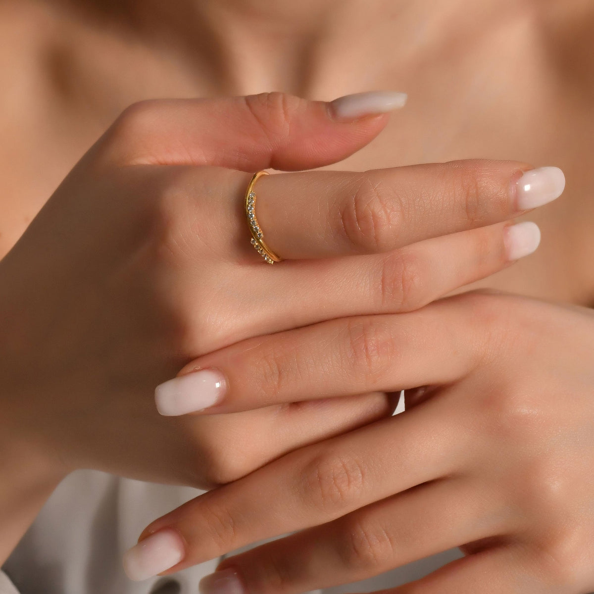 14K gold curved wave diamond ring worn on hand, side view