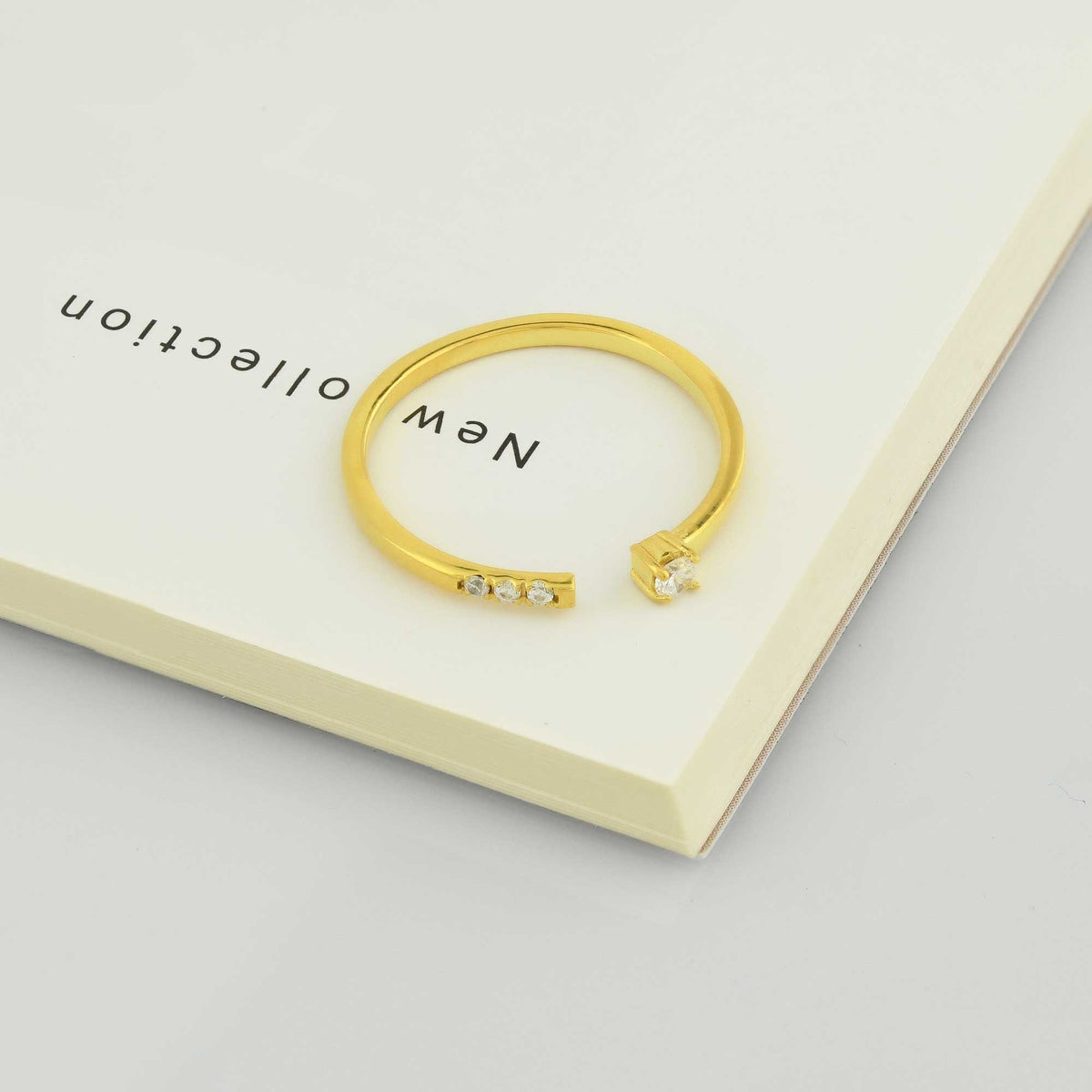 14K gold open cuff diamond ring on display