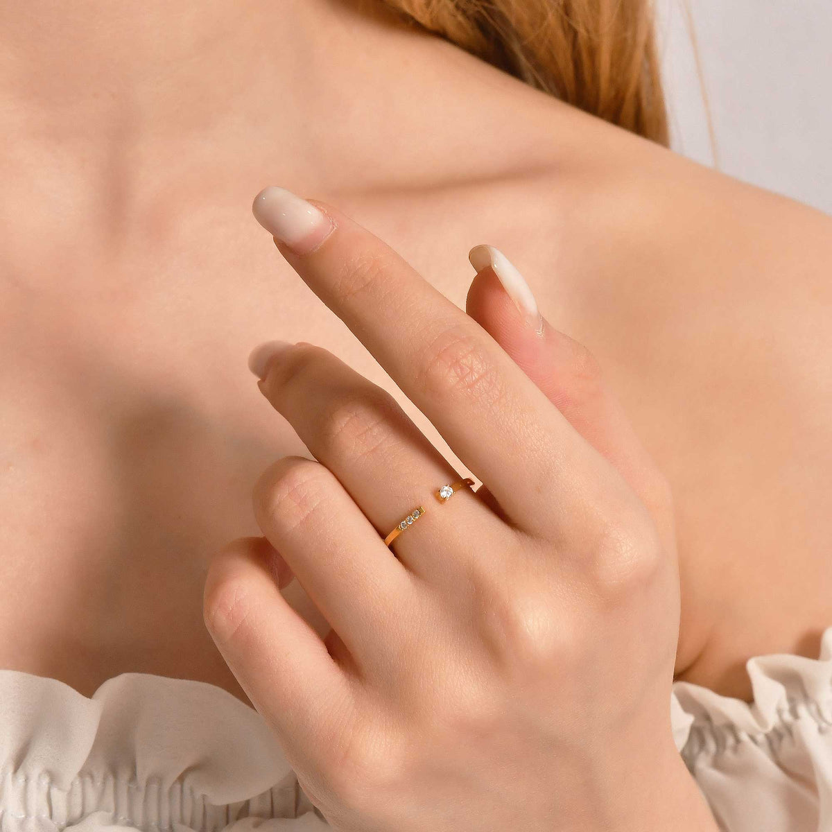 10K gold open cuff cubic zirconia ring on raised hand