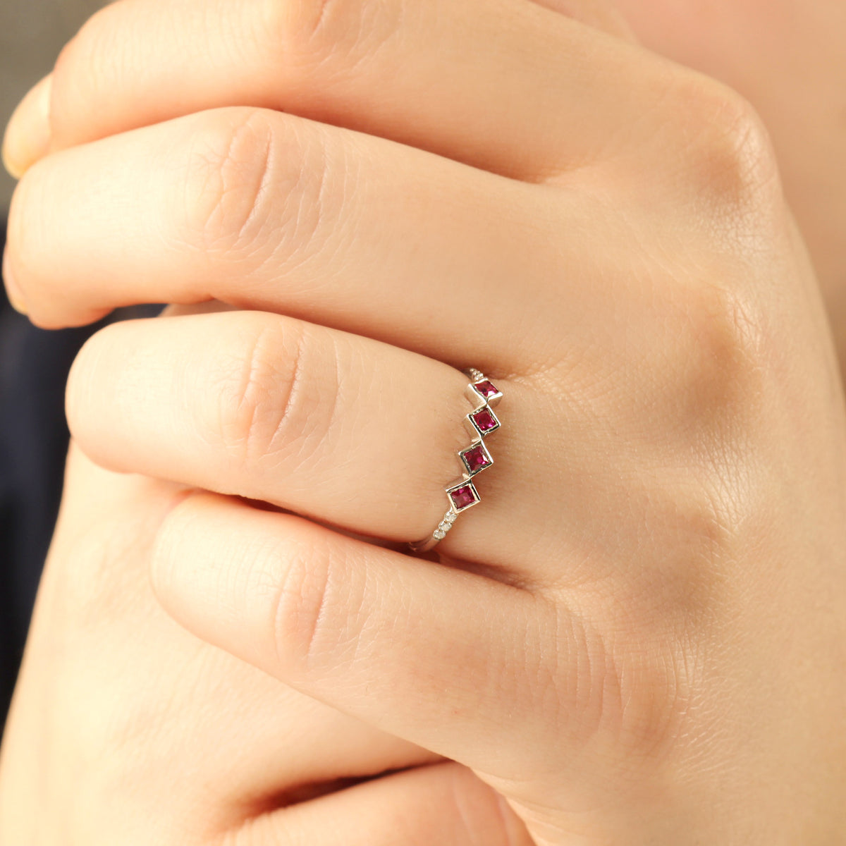 10K gold red stone four princess cubic zirconia ring worn on hand, side view