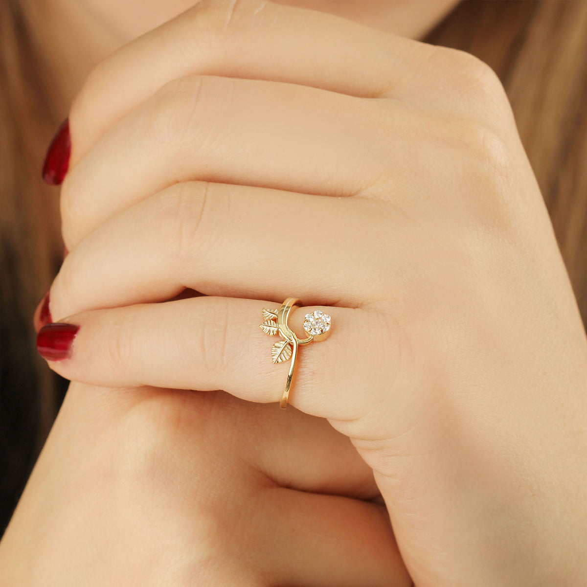 14K gold cluster leaf diamond ring on hand, natural light