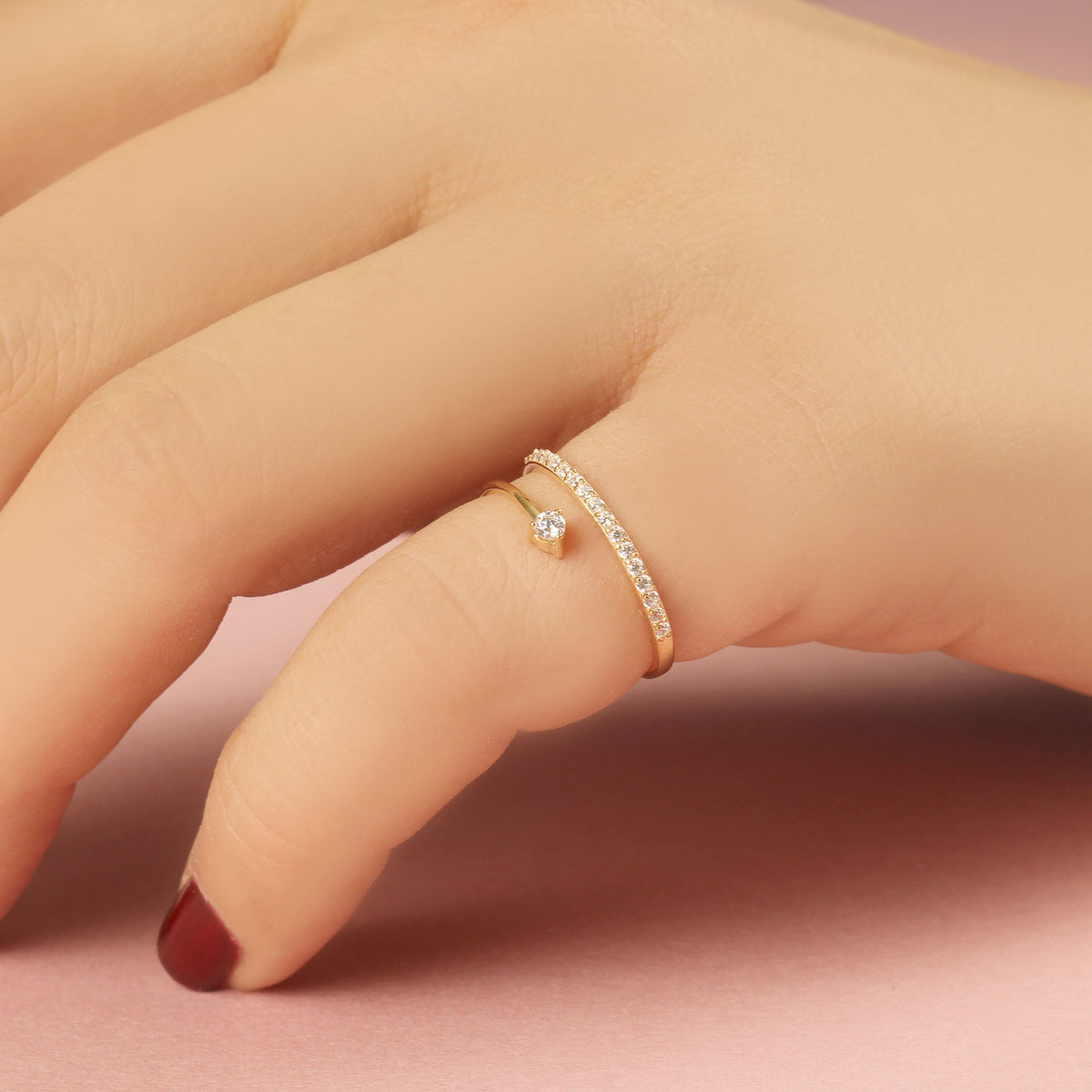 14K gold pave swirl cubic zirconia ring on raised hand