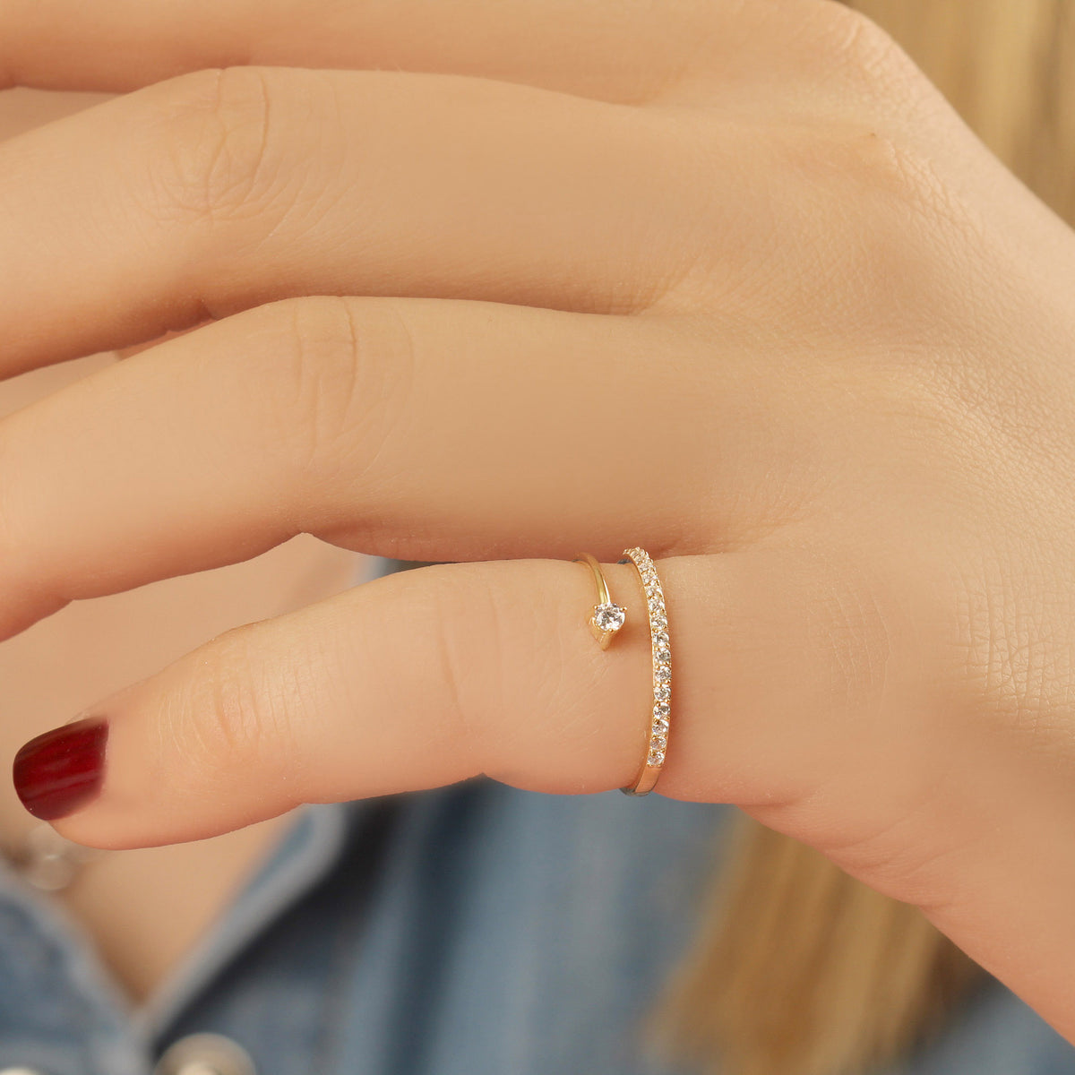 18K gold pave swirl cubic zirconia ring worn on hand, close-up