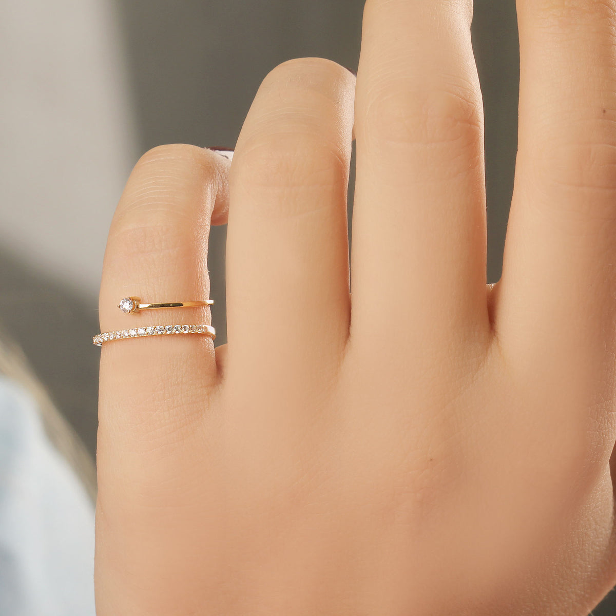 18K gold pave swirl cubic zirconia ring on hand, natural light
