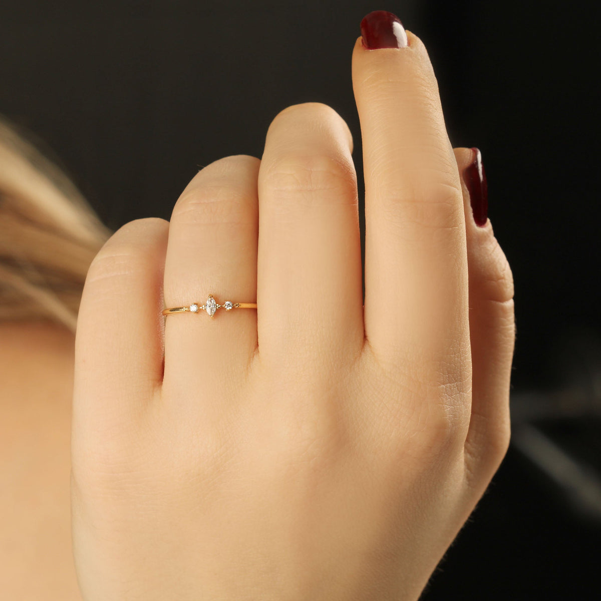 10K gold marquise cubic zirconia ring on finger, close-up