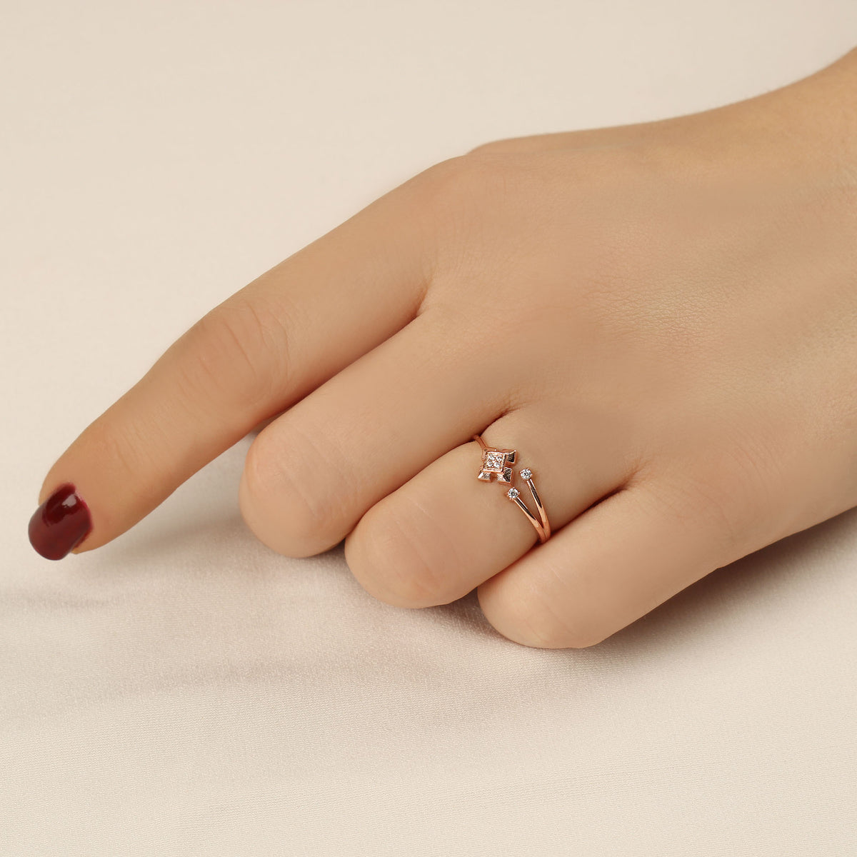 14K gold open geometric cubic zirconia ring worn on hand, close-up