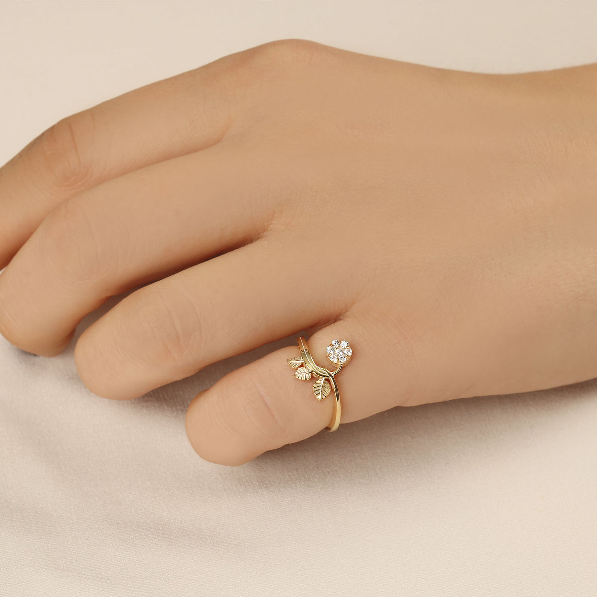 18K gold cluster leaf cubic zirconia ring worn on hand, side view