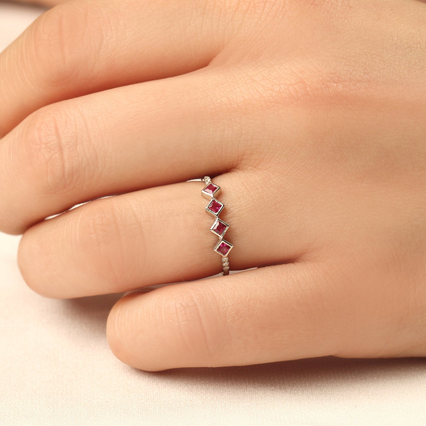 18K gold red stone four princess cubic zirconia ring worn on hand