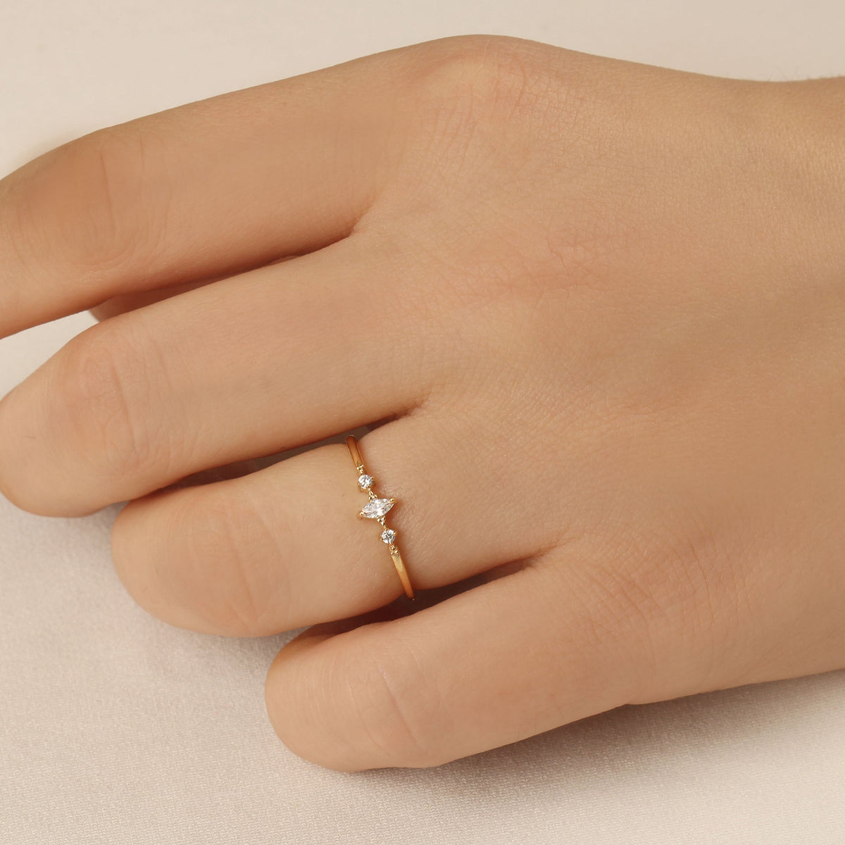 14K gold marquise cubic zirconia ring worn on hand