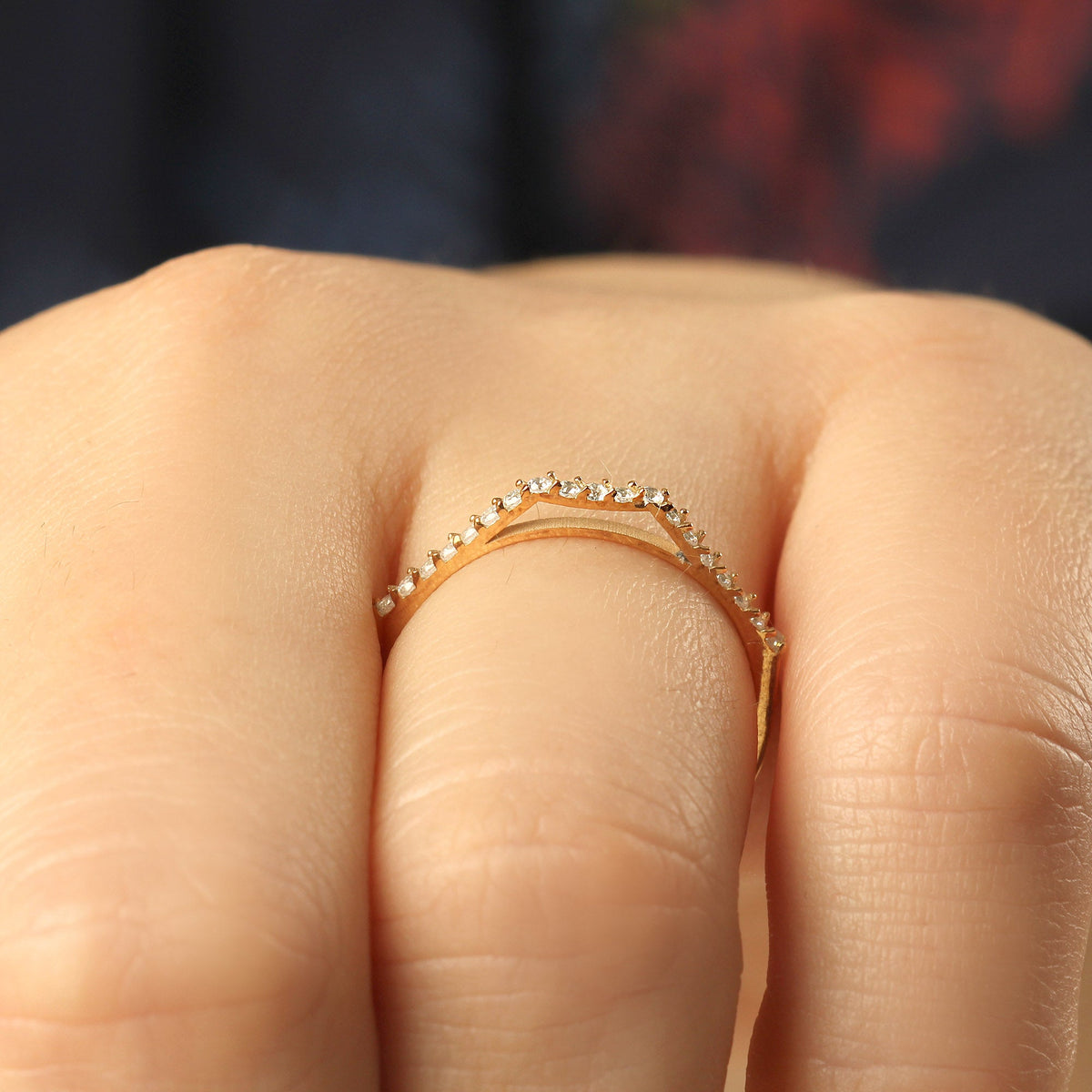 18K gold chevron cubic zirconia ring on finger, close-up