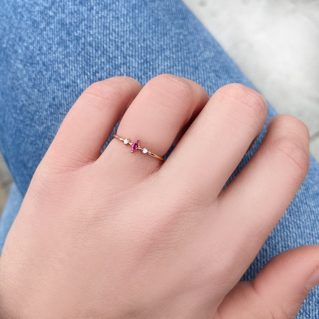10K gold red-stone marquise diamond ring worn on hand