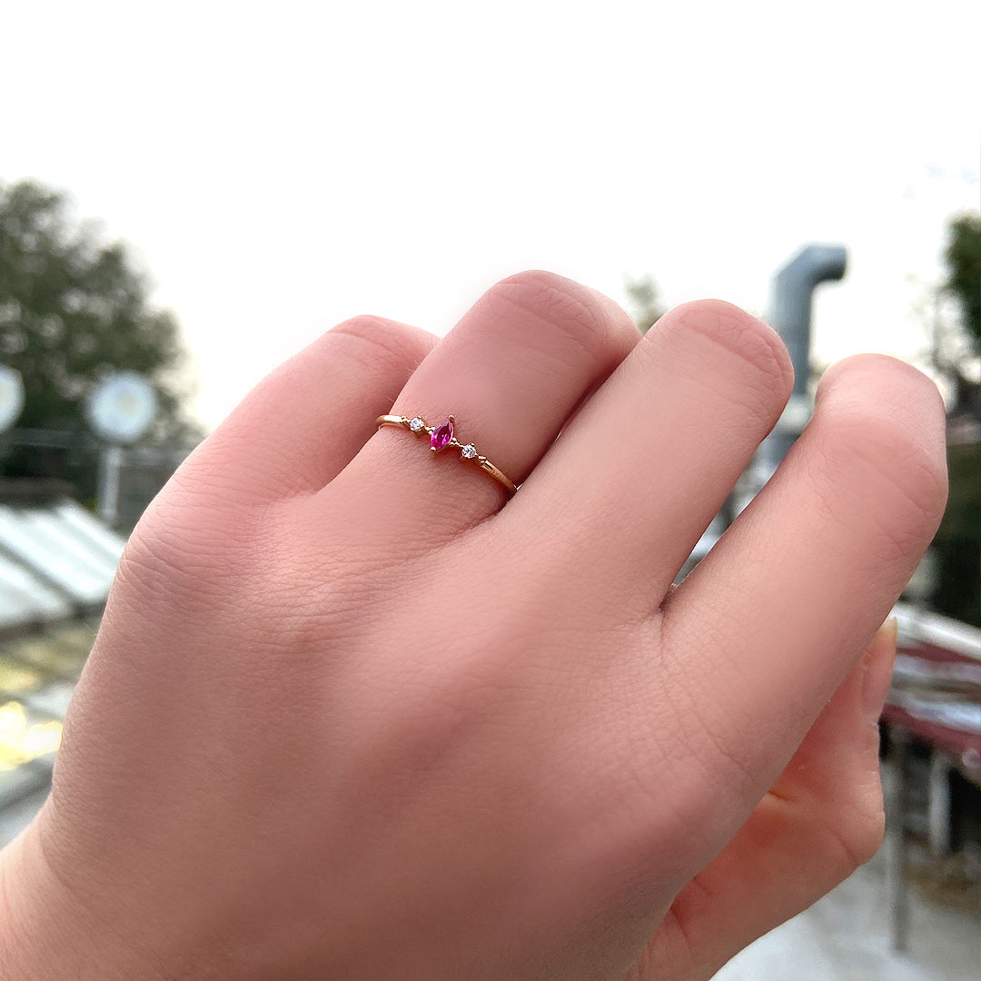 10K gold red-stone marquise cubic zirconia ring worn on hand, side view